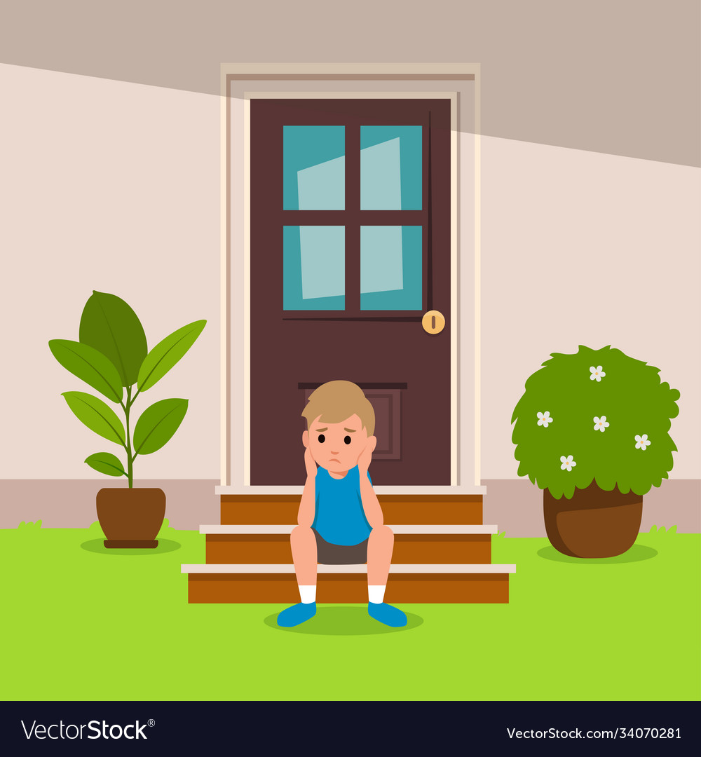 a girl and a boy holding a house cutout sitting in the grass on a