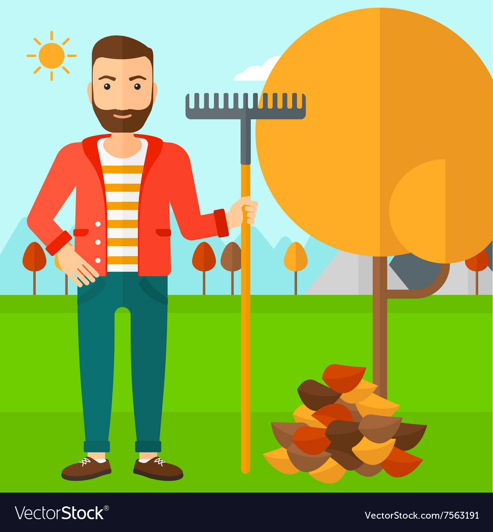 Man with rake standing near tree and heap