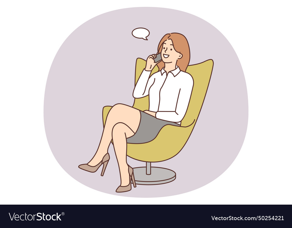 Smiling businesswoman in chair talking on cell