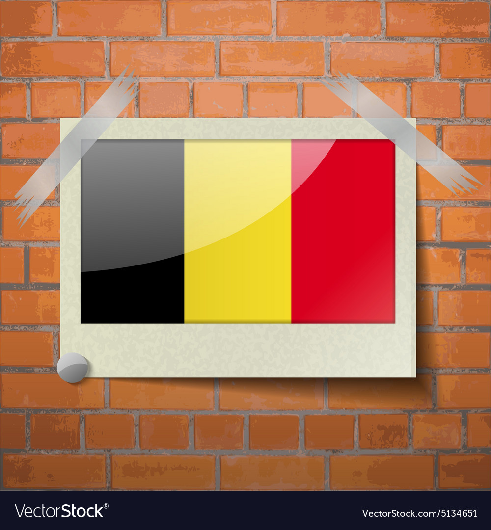 Flags belgium scotch taped to a red brick wall