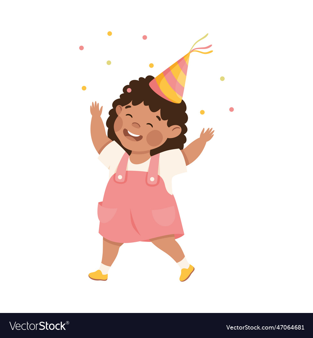 Happy little girl in birthday party hat having fun