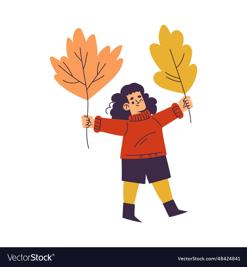 Little girl in fall season holding huge leaf enjoy