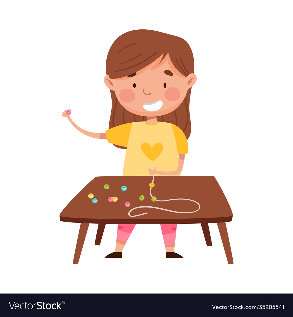 Cute girl standing at table and stringing beads