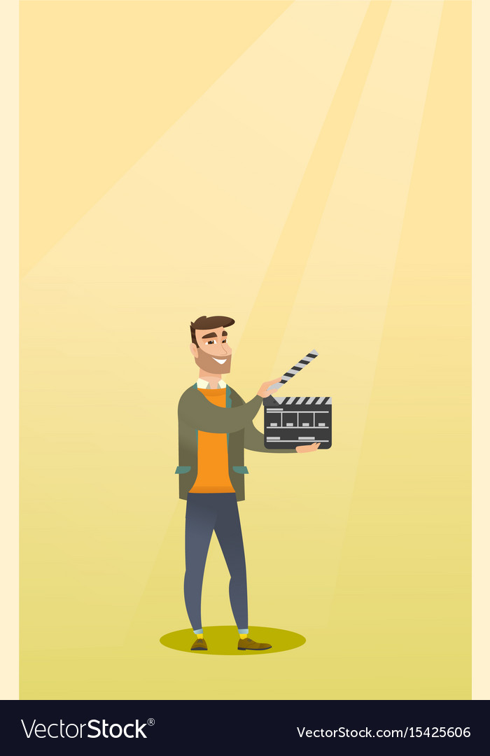 Smiling man holding an open clapperboard