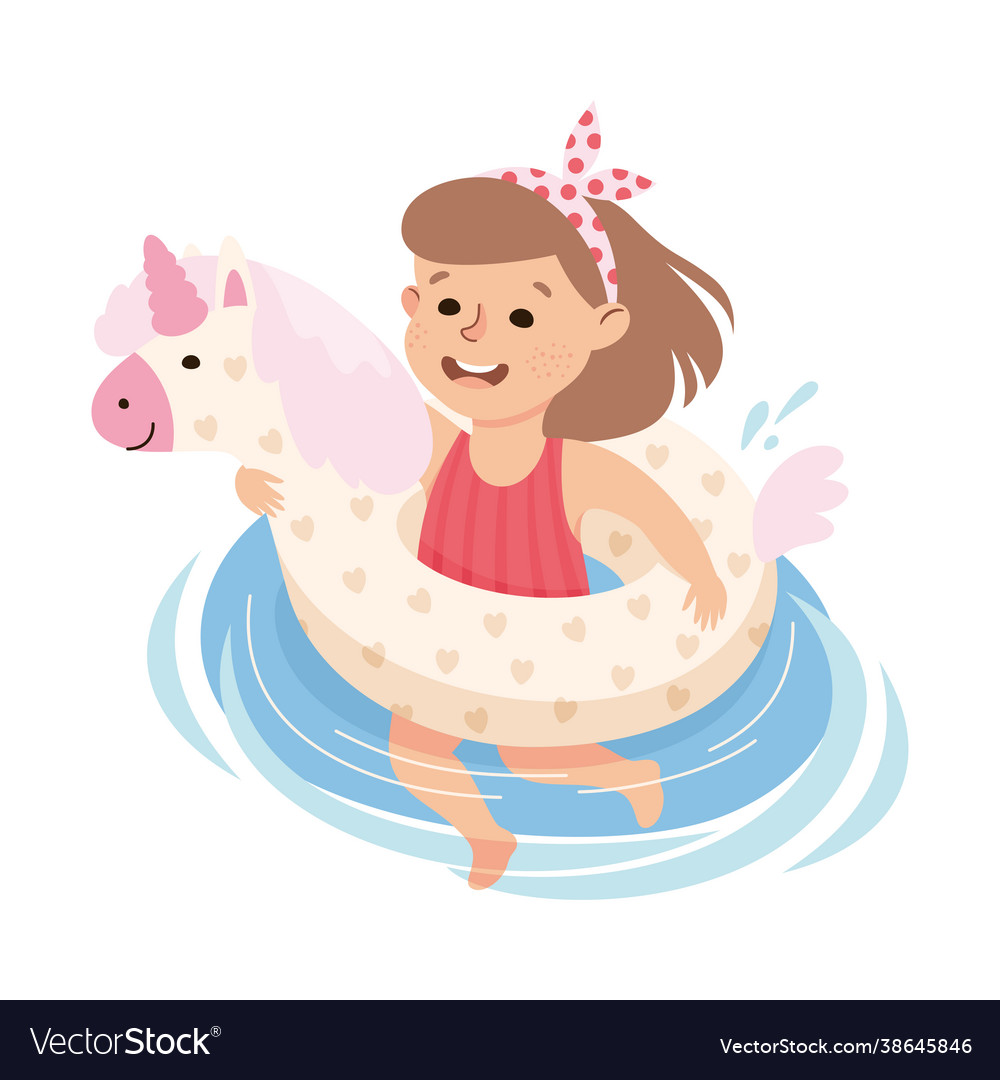 Little girl in swimsuit swimming with unicorn