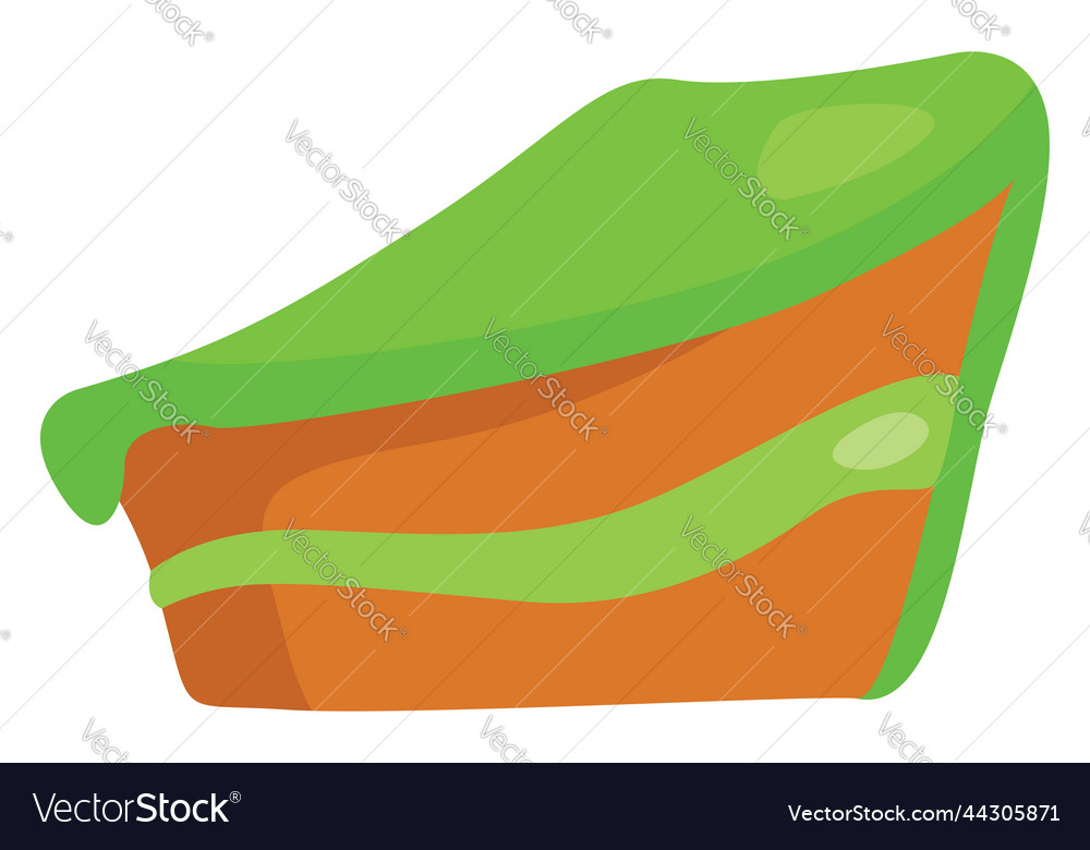 Slice of cake with green icing on a white