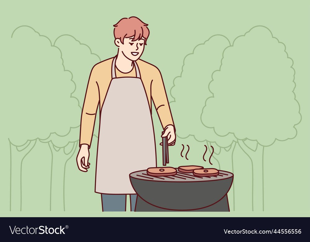 Man in apron cook meat outdoors