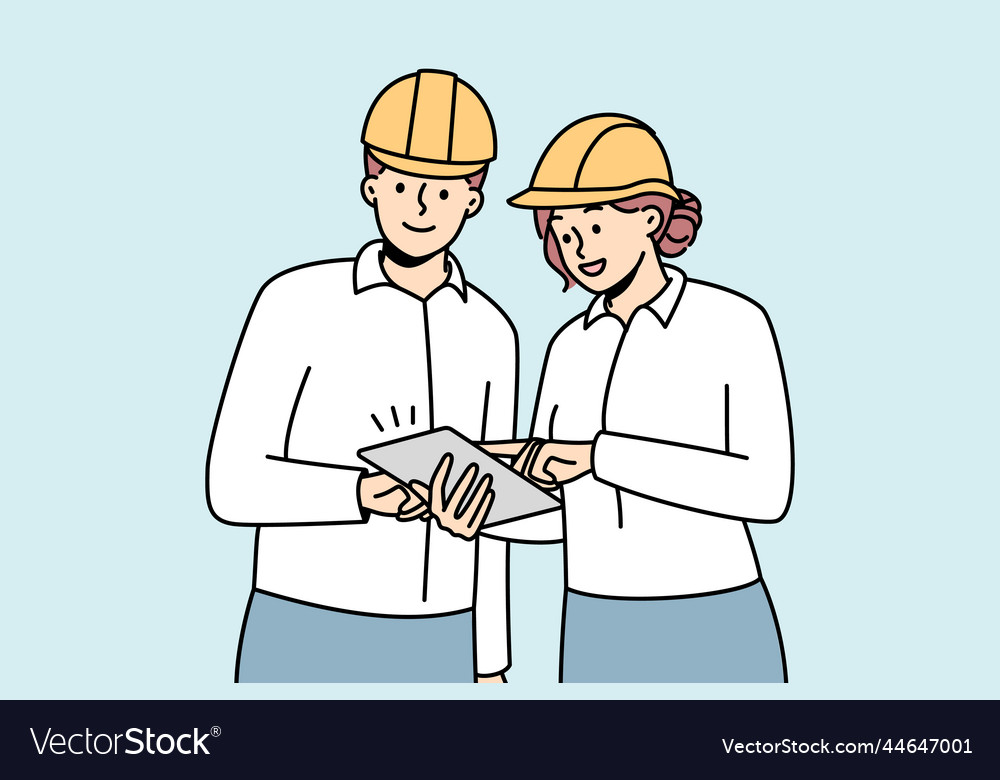 Smiling engineers in helmets cooperating