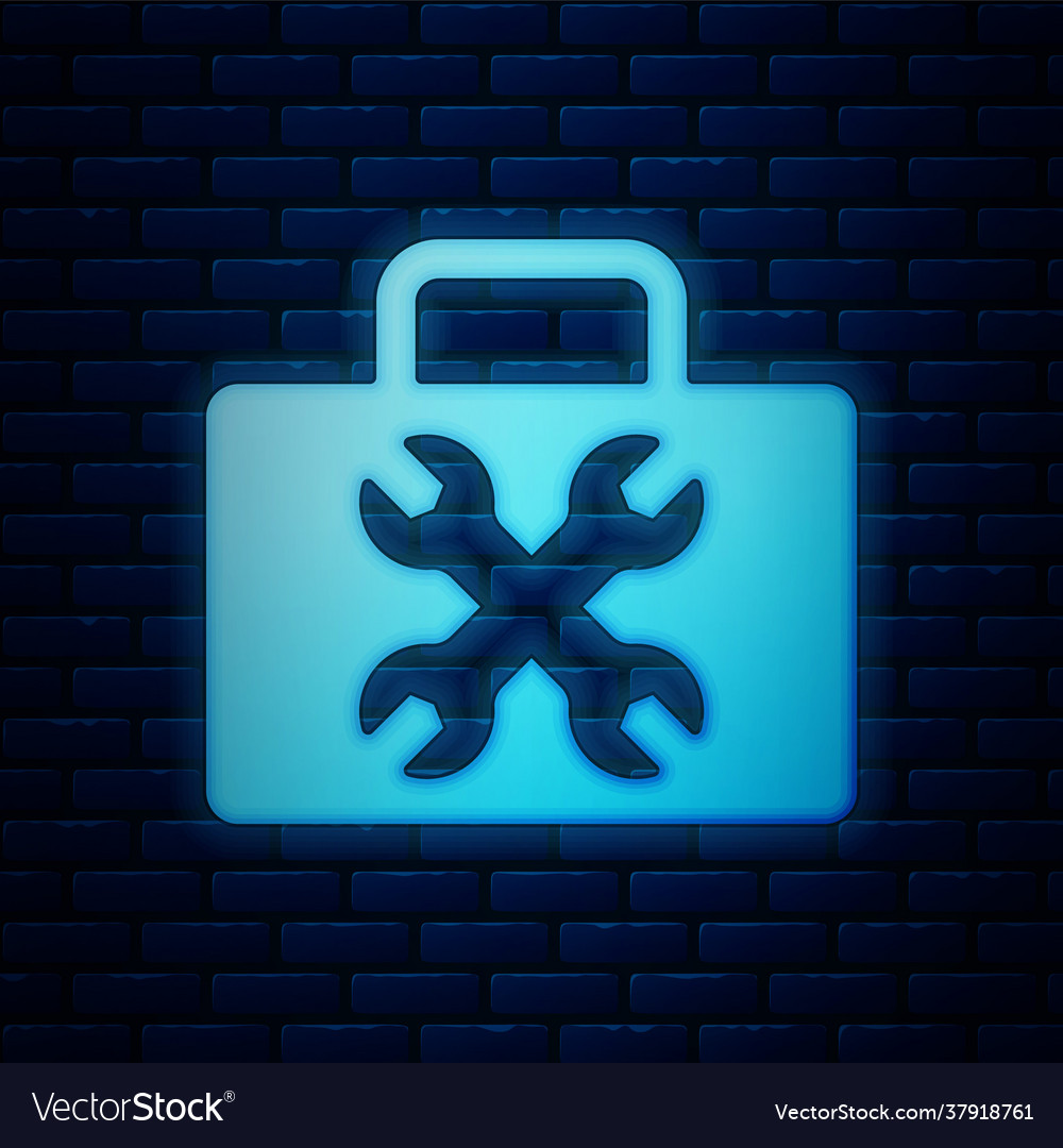 Glowing neon toolbox icon isolated on brick wall