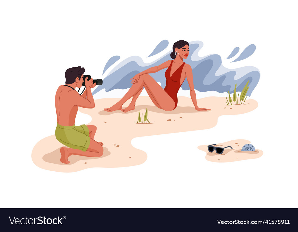 Man photographing pretty woman on the beach