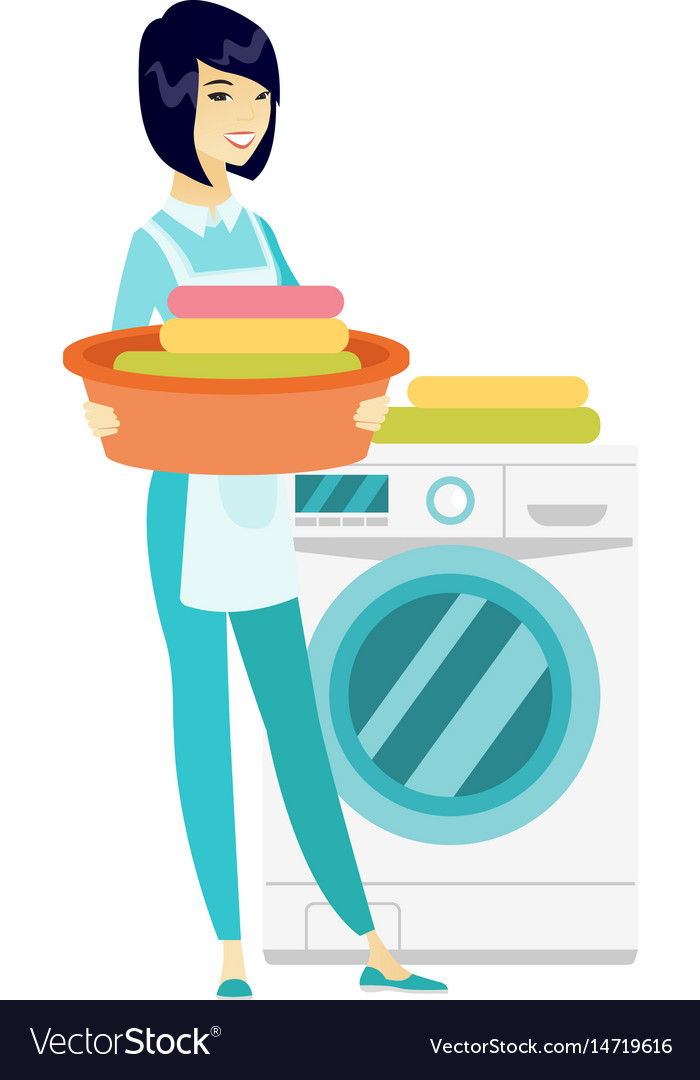 Housewife using washing machine at laundry