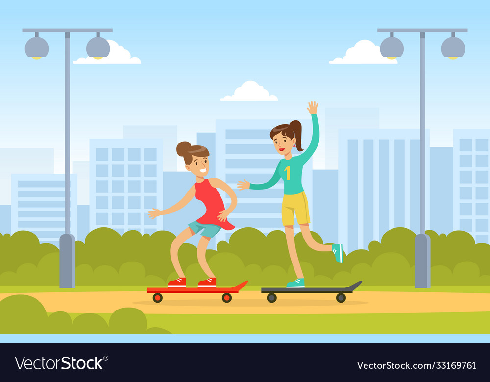 Two young women riding skateboards in park