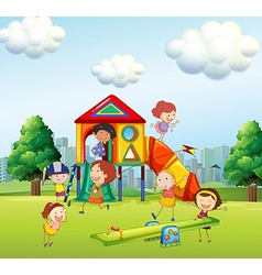 Smiling kids playing at the playground Royalty Free Vector