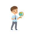 cute boy standing with globe at geography lesson vector image