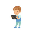 cute little boy standing with a tablet pc vector image