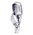 antique microphone and skeleton hand vector image