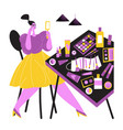 girl paints her eyes sitting at the table vector image vector image