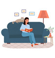 young woman is sitting on couch and reading book vector image