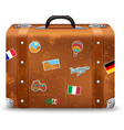 old suitcase with travel stickers vector image