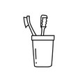two toothbrushes in a cup outline vector image