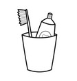 toothpaste and toothbrush in a glass black vector image