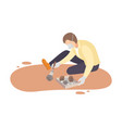male archaeologist sitting on ground and sweeping vector image